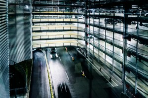 Multi-level covered parking garage with parking lofts, at night