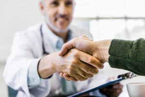 Doctor shaking hands with patient in clinic