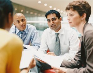 Business People Sitting in an Office Building Chatting